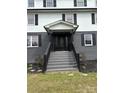 Elegant front door with decorative glass detailing, flanked by black shutters and professional landscaping at 330 Skyview Dr, Catawba, SC 29704