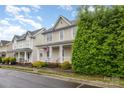 Attractive two-story home featuring a charming front porch and lush green landscaping at 3906 Balsam St, Indian Trail, NC 28079