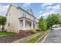 Beautiful home boasting a cozy front porch, tidy landscaping, and a picturesque setting at 3906 Balsam St, Indian Trail, NC 28079