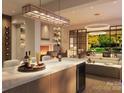 Open-concept kitchen features island seating, a fireplace, and glass doors opening to a bright outdoor living area at 409 Queens Rd # 401, Charlotte, NC 28207