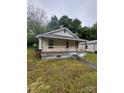 Charming home featuring a cozy front porch and a well-maintained lawn at 415 Orange St, Shelby, NC 28150