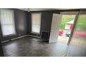 The living room features tile flooring and natural light from two windows at 415 Orange St, Shelby, NC 28150