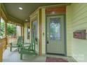 Inviting front porch with seating, a decorative door, and intricate trim details at 416 E Park Ave, Charlotte, NC 28203