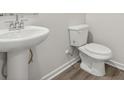 Bathroom featuring a pedestal sink, toilet, and modern fixtures set against neutral walls at 417 Bent Burr Crk, York, SC 29745