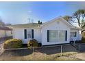 Inviting single-story home with a classic white exterior, green shutters, and neat landscaping at 447 17Th St, Cramerton, NC 28032