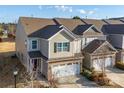 A cozy townhome featuring a 2-car garage, and neutral-toned siding complemented by an inviting facade at 5062 Gribble Ln, Lancaster, SC 29720