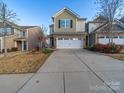 Inviting townhome with a 2-car garage, stone accents, neutral siding, and a well-manicured front yard at 5062 Gribble Ln, Lancaster, SC 29720