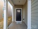 Inviting covered entryway with a black front door and a 'Welcome Home' mat at 5062 Gribble Ln, Lancaster, SC 29720
