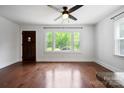 Bright living room featuring hardwood floors and a large window offering a view of the outside at 534 W Kingston Ave, Charlotte, NC 28203