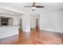 Open-concept living area with hardwood floors, seamlessly connected to a bright kitchen with white cabinetry at 534 W Kingston Ave, Charlotte, NC 28203