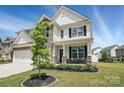 Charming home featuring stone accents, black shutters, a covered porch, and well-maintained landscaping at 6416 Willow Pin Ln, Huntersville, NC 28078