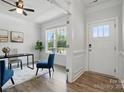 Bright office space with hardwood floors, a large window, and a stylish accent chair, plus front door view at 6416 Willow Pin Ln, Huntersville, NC 28078