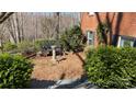 Serene garden area featuring a bench, birdbath, and beautiful landscaping at 700 Valleyview Dr # 1, Albemarle, NC 28001