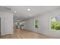Open-concept living room with light wood floors leading to the kitchen at 706 Live Oak St, Shelby, NC 28150