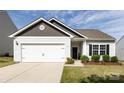 Inviting single-story home showcasing a two-car garage, neatly landscaped front yard, and welcoming entrance at 7315 Amberly Hills Rd, Charlotte, NC 28215