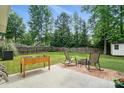 Spacious backyard with a fire pit, patio, fenced perimeter, and lush lawn for outdoor enjoyment at 8381 Chatsworth Dr, Indian Land, SC 29707