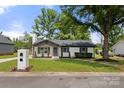 Quaint single-Gathering home featuring a lovely landscaped front yard, painted brick, and a brick mailbox at 1067 Winchester Dr, Rock Hill, SC 29730