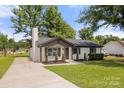 Attractive home with fresh landscaping, painted brick, chimney, and a long concrete driveway at 1067 Winchester Dr, Rock Hill, SC 29730