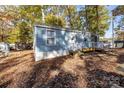 Cozy light blue home with small deck, surrounded by mature trees and fall foliage at 108 Sailors Ct # 108 B, Mount Gilead, NC 27306