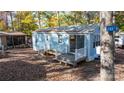 Charming light blue home with a small deck, set among mature trees and foliage at 108 Sailors Ct # 108 B, Mount Gilead, NC 27306