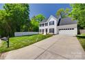 Charming two-story home featuring a manicured lawn, picket fence, and a spacious driveway at 1134 Blueberry Ln, Charlotte, NC 28226