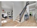 Bright foyer with hardwood floors, staircase, and access to a living area at 1134 Blueberry Ln, Charlotte, NC 28226