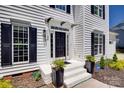 Elegant front entrance with black door, white trim, and manicured landscaping at 1134 Blueberry Ln, Charlotte, NC 28226