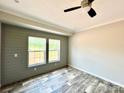 Bedroom with wood-look floors, two windows, and a ceiling fan at 118 Brett Will Ct, Taylorsville, NC 28681