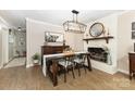 Dining room with a brick fireplace, modern chandelier, and stylish decor at 127 Leonidas St, Fort Mill, SC 29715