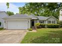 Inviting single-story home with a well-maintained lawn and attached garage at 1321 Land Grant Rd, Charlotte, NC 28217