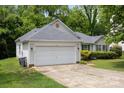 Home featuring an attached two-car garage and a well-kept lawn at 1321 Land Grant Rd, Charlotte, NC 28217