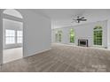 Open living room with a fireplace and large windows allowing natural light at 1321 Land Grant Rd, Charlotte, NC 28217