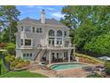 Stunning home featuring a pool, patio, balcony, lush landscaping, and plenty of room for outdoor entertaining at 17938 John Connor Rd, Cornelius, NC 28031