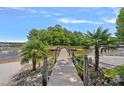 Picturesque dock with palm trees along the shoreline and leading to a tranquil lake at 17938 John Connor Rd, Cornelius, NC 28031