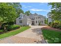 Elegant exterior view of this magnificent home, showcasing the well-manicured lawn and inviting driveway at 17938 John Connor Rd, Cornelius, NC 28031