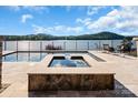 Inviting hot tub overlooks a serene lake view with an expansive paver deck, perfect for relaxation and entertainment at 204 Ridge Dr # 12 12-1 12-2, Troy, NC 27371