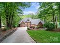 Charming brick home with three-car garage, landscaped yard, and an inviting driveway at 2200 Capes Cove Dr, Sherrills Ford, NC 28673