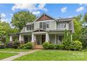 Charming two-story home with a beautiful front porch and manicured landscaping at 2414 Bay St, Charlotte, NC 28205