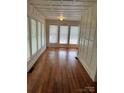 Bright living room featuring hardwood floors, wainscotting, and large windows at 273 E Main Ave, Taylorsville, NC 28681
