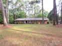 Traditional brick home on a large lot with mature trees and a spacious front yard in a quiet neighborhood at 3316 Mckee Rd, Charlotte, NC 28270