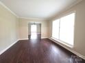 Bright living room with beautiful wood-look floors, neutral walls, and large windows allowing ample natural light at 3316 Mckee Rd, Charlotte, NC 28270