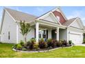 Inviting front porch with manicured landscaping and decorative hanging plants creating curb appeal at 4046 Starfire Ln, Rock Hill, SC 29732
