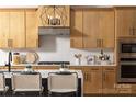 Well-appointed kitchen featuring modern cabinetry, stainless steel appliances, and a breakfast bar at 4209 Pinekirk Dr # 374, Charlotte, NC 28269