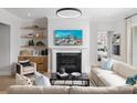 Bright living room featuring a modern fireplace, stylish furniture, and decorative shelving at 4209 Pinekirk Dr # 374, Charlotte, NC 28269