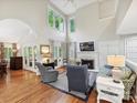 Bright living room with vaulted ceilings, fireplace, and ample natural light from large windows at 6647 Gaywind Dr, Charlotte, NC 28226