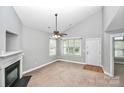 Bright living room with a fireplace, lots of natural light, and a welcoming atmosphere at 6705 E Douglas Park Dr, Huntersville, NC 28078