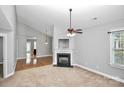 Spacious living room with fireplace, ceiling fan, neutral walls and plenty of natural light at 6705 E Douglas Park Dr, Huntersville, NC 28078