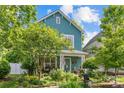 Charming two-story home featuring a landscaped yard and inviting curb appeal on a beautiful sunny day at 6827 Dunton St, Huntersville, NC 28078