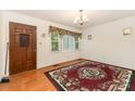 Dining room featuring hardwood floors, vintage chandelier, and large window providing ample natural light at 6934 Lockhart Rd, Sharon, SC 29742