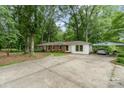 View of a brick home with a covered parking area, spacious driveway and ample space for parking at 6934 Lockhart Rd, Sharon, SC 29742